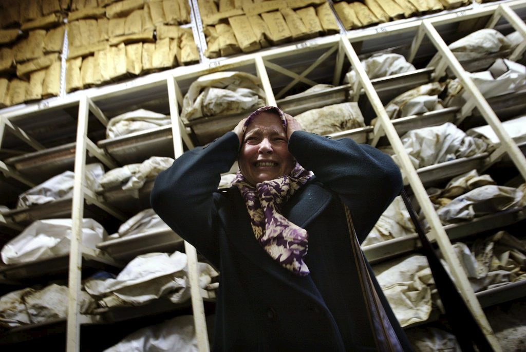 Aida Civic, a Bosnian Muslim refugee woman from Srebrenica, screams as she enters a container with the remains of around 3,500 killed Bosnian Muslims, most of them from Srebrenica, in an identification centre of the Institute for missing persons in Tuzla in this December 10, 2002 file photo. Twenty years ago on July 11, 1995, towards the end of Bosnia's 1992-95 war, Bosnian Serb forces swept into the eastern Srebrenica enclave, a U.N.-designated "safe haven". There they took 8,000 Muslim men and boys and executed them in the days that followed, dumping their bodies into pits in the surrounding forests.     REUTERS/Damir Sagolj/Files  TPX IMAGES OF THE DAY FROM THE FILES PACKAGE âSREBRENICA MASSACRE - 20TH ANNIVERSARYâ? SEARCH âSREBRENICA MASSACREâ? FOR ALL 15 IMAGES      TPX IMAGES OF THE DAY