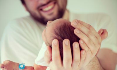 Muslim father holds newborn baby