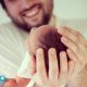 Muslim father holds newborn baby