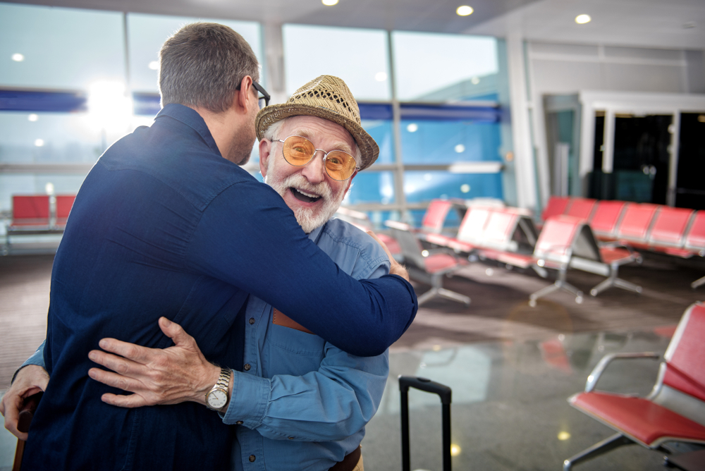 Elderly Muslim father hugging son